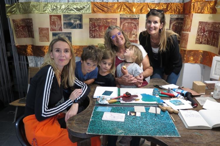 Cendrine Rempenault et des « stagiaires ». Derrière elles, une fresque réalisée à l’estampe.